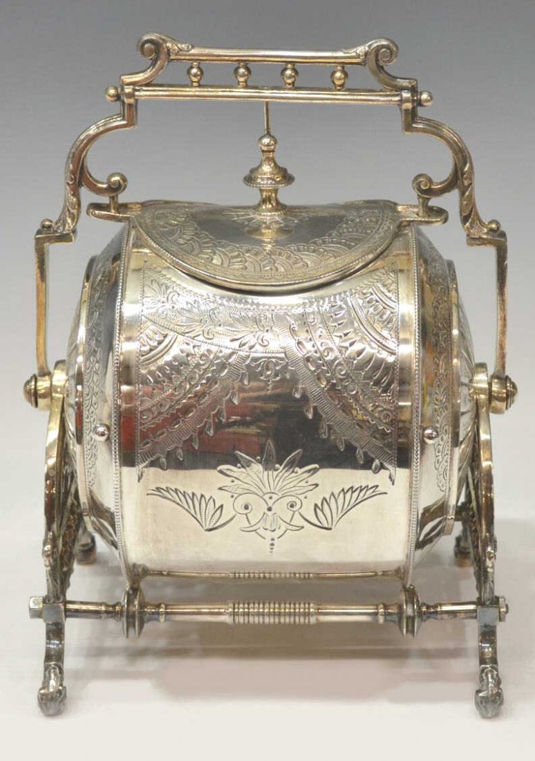 AESTHETIC SHEFFIELD SILVER PLATE MUFFIN WARMER: Sheffield silver plate muffineer, Philip Ashberry & Sons, c. 1852, Aesthetic decor on the cylindrical box, with lift lid, held by a spindled frame, on scrolled foliate feet, 10"h, 7.25"w, 5.5"d Start 