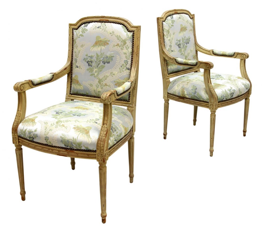 (PAIR) LOUIS XVI STYLE CHAIRS, STONELEIGH LTD.: (lot of 2) Louis XVI style arm chairs by Stoneleigh Ltd., N.C., an arched crest rail over floral and foliate upholstery framed by padded arms with scrolled handholds, rising on tapered ribbed legs wit