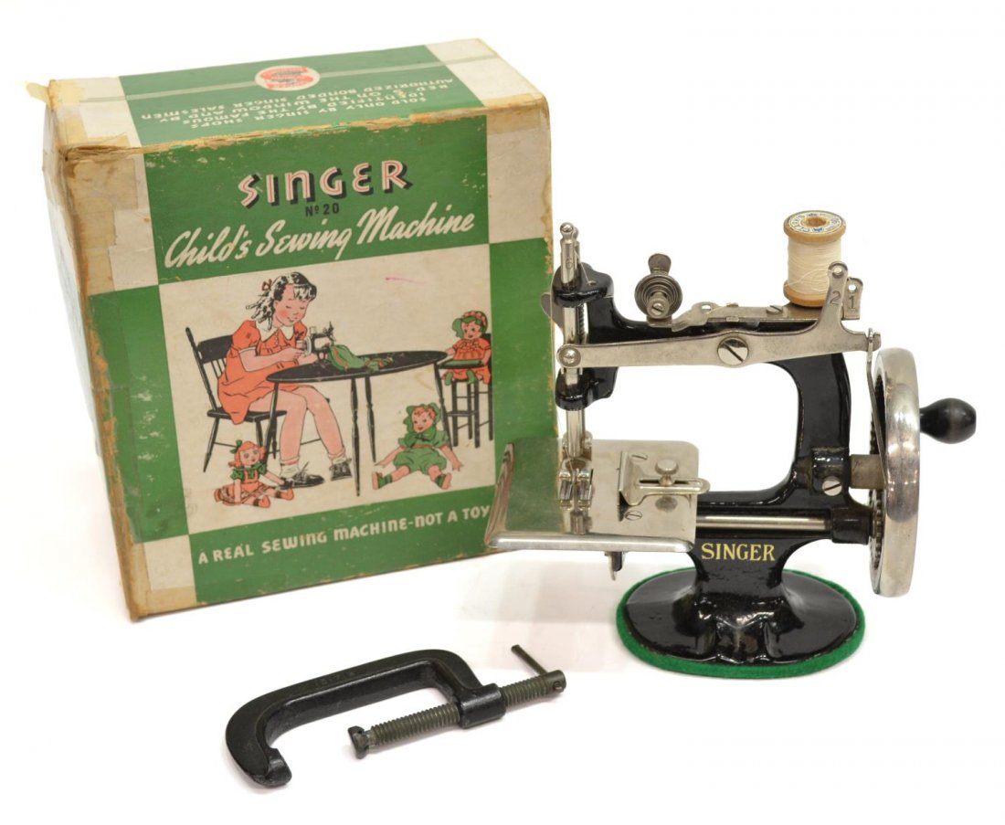 VINTAGE SINGER CHILD'S BLACK IRON SEWING MACHINE: Vintage Singer child's sewing machine, model number 20, retaining original box and clamp, sewing machine: 7"h, 7"w, 3.5"d, box: 4"h, 7"w, 7.5"d, 3.75lbs Start Price: $60.00