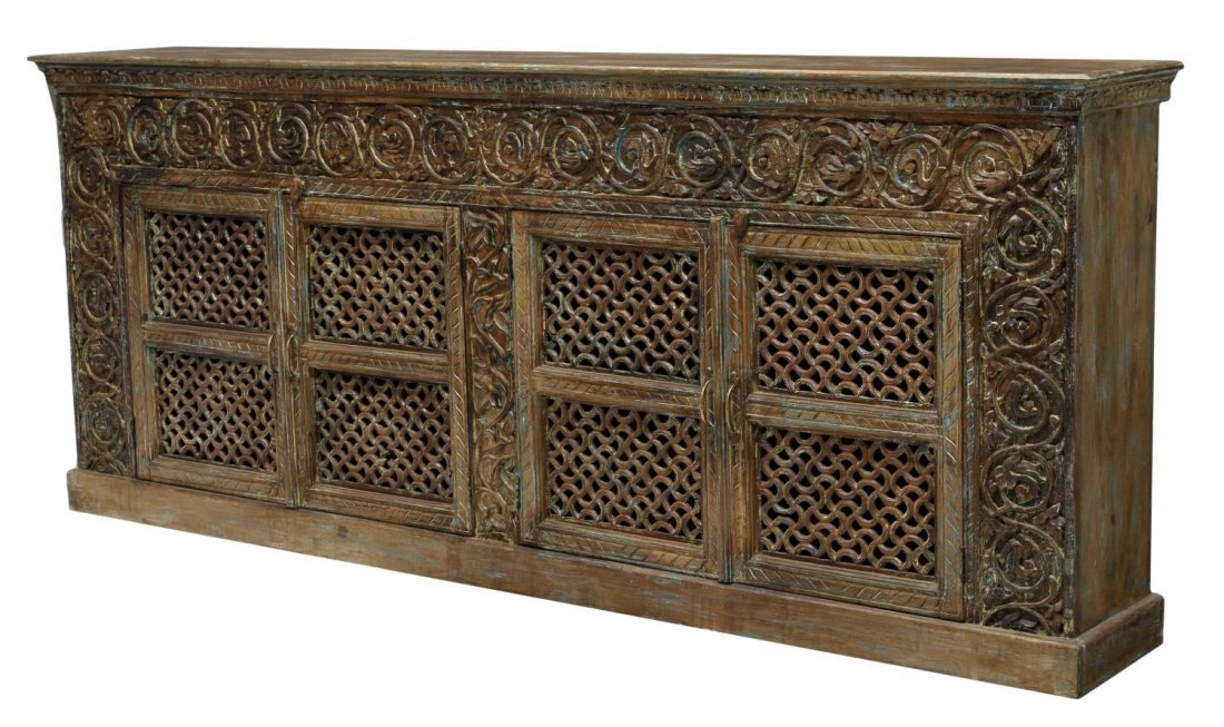 LARGE DECORATIVE FOLIATE CARVED SIDEBOARD: Large decorative teakwood sideboard, a rectangular top over the foliate carved frieze and front sides flanking four foliate carved lattice decorated doors opening to the shelved interior, rising on a 