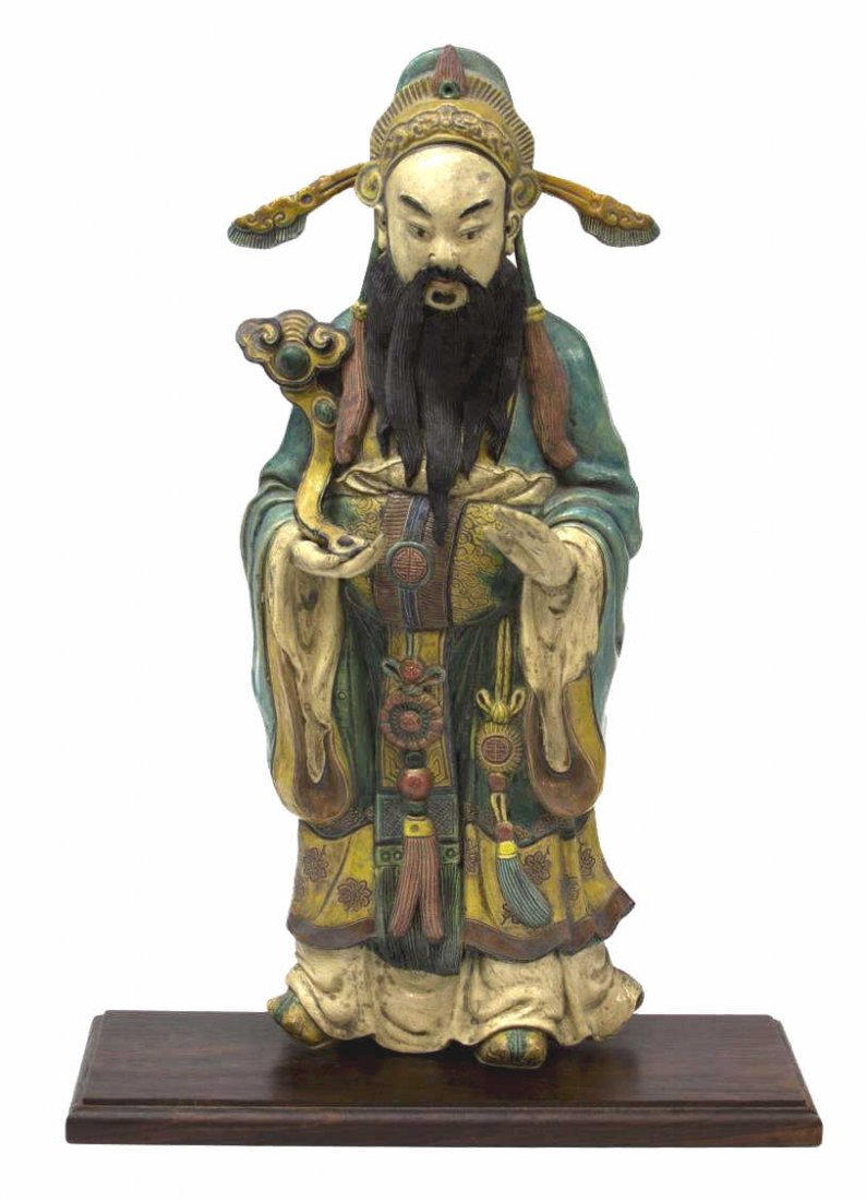 CHINESE GLAZED EARTHENWARE ARCHITECTURAL FIGURE: Chinese polychrome glazed stoneware roof tile, modeled as a Chinese scholar- official dressed in traditional clothing holding a ruyi scepter, mounted on a wooden base, repair to head dress, 20.5"h, 12