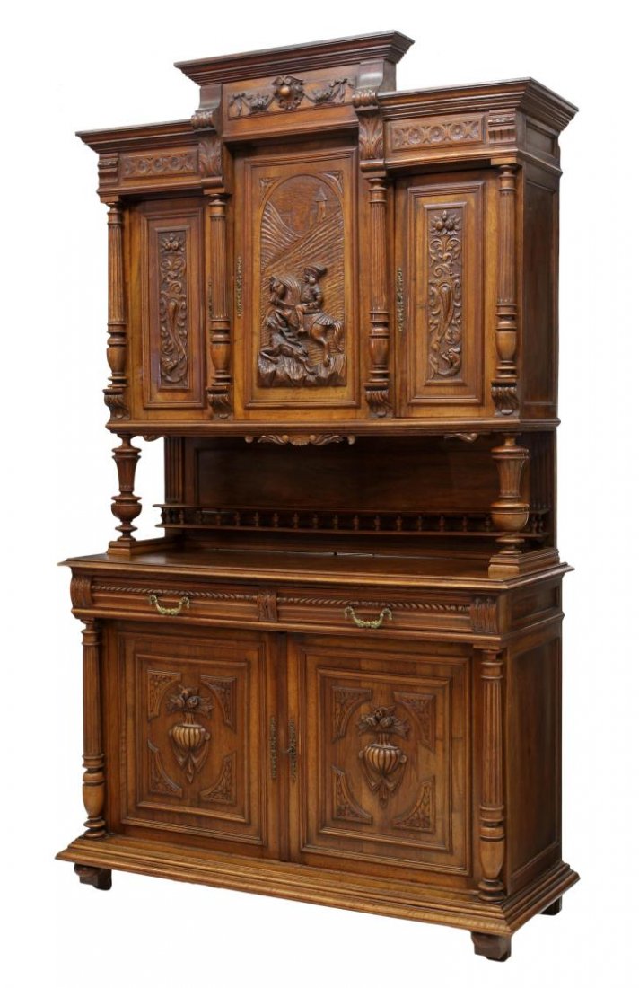 FRENCH HENRI II STYLE CUPBOARD, FIGURAL CARVING: French Henri II style carved walnut hunt cupboard, late 19th c., the stepped cornice surmounting the upper cabinet set with three doors, the central door carved in a relief hunt scene with a rider on 