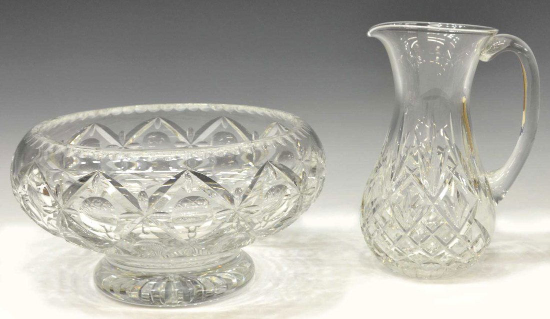 (2) WEBB CRYSTAL PUNCH BOWL & WATERFORD PITCHER: (lot of 2) Colorless cut crystal tableware, comprising: (1) Thomas Webb punchbowl of squat round form, c. 1950-1966, having a circle and cross work pattern, raised base with starburst motif, acid mark