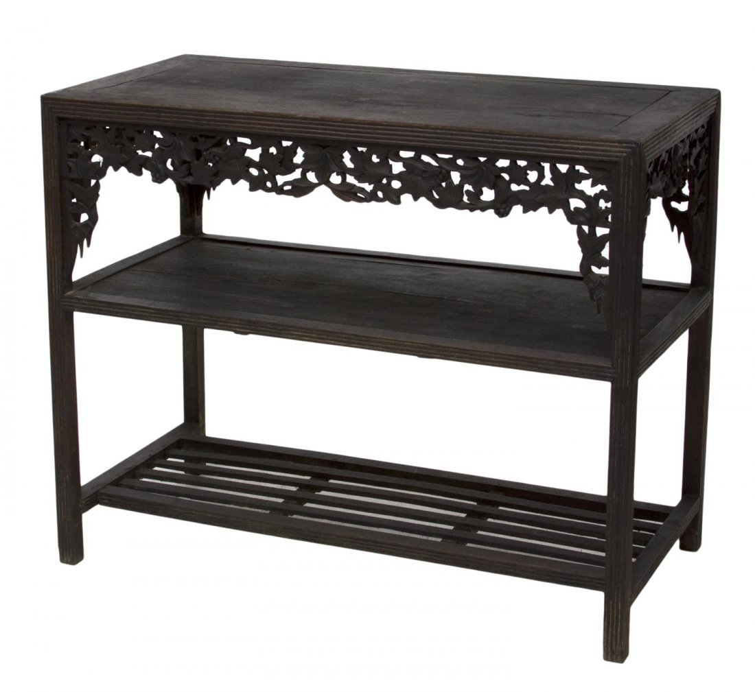 FRENCH COLONIAL CARVED WORK TABLE: French Colonial hardwood work table, early 20th c., the rectangular top with pierced foliate carved skirt over a lower shelf, the grooved square legs joined by lower slat covered stretchers, wood spli