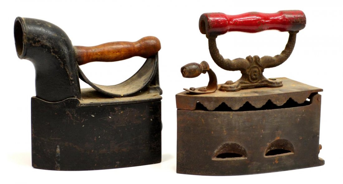 (2) GROUP OF VINTAGE CHARCOAL IRONS: (lot of 2) Vintage charcoal irons, (1) with a chimney and wood handle, (1) with a scalloped lid and red wood handle, marked Germanic, largest: 8.5"h, 7.75"l, 12.25lbs total Start Price: $50.00