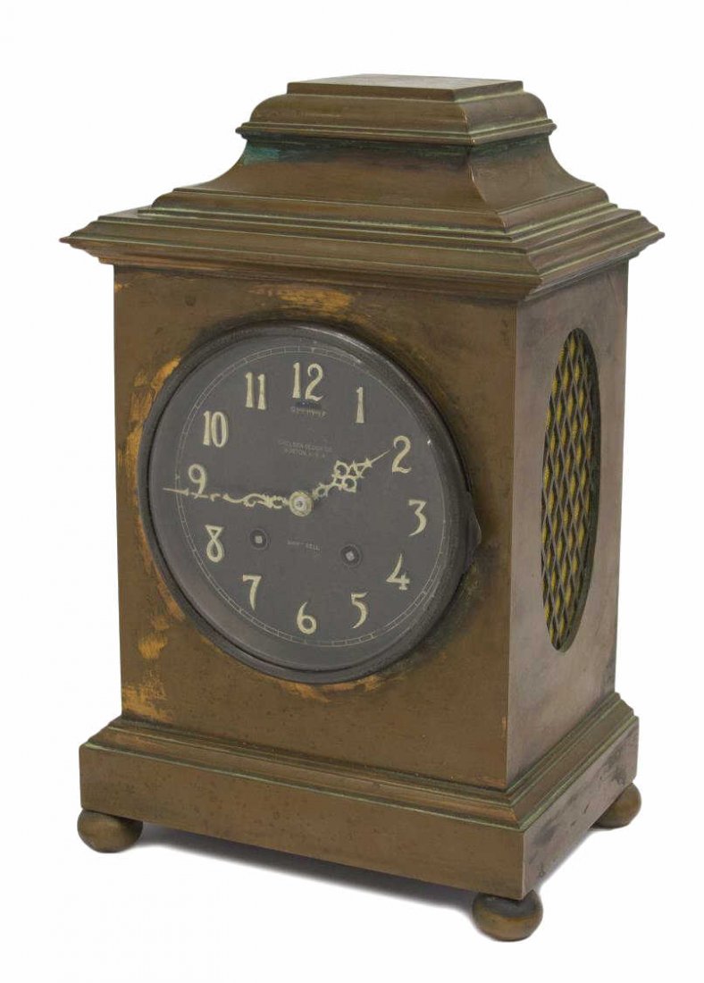 UNUSUAL BRONZE CHEALSEA CLOCK CO. SHIPS BELL CLOCK: Bronze cased Chelsea Clock Co. ships bell clock, the face marked with Arabic numbers and ships bell, time and strike movement, rising on four bun feet, works marked Chelsea Clock Co., retaining key, 1