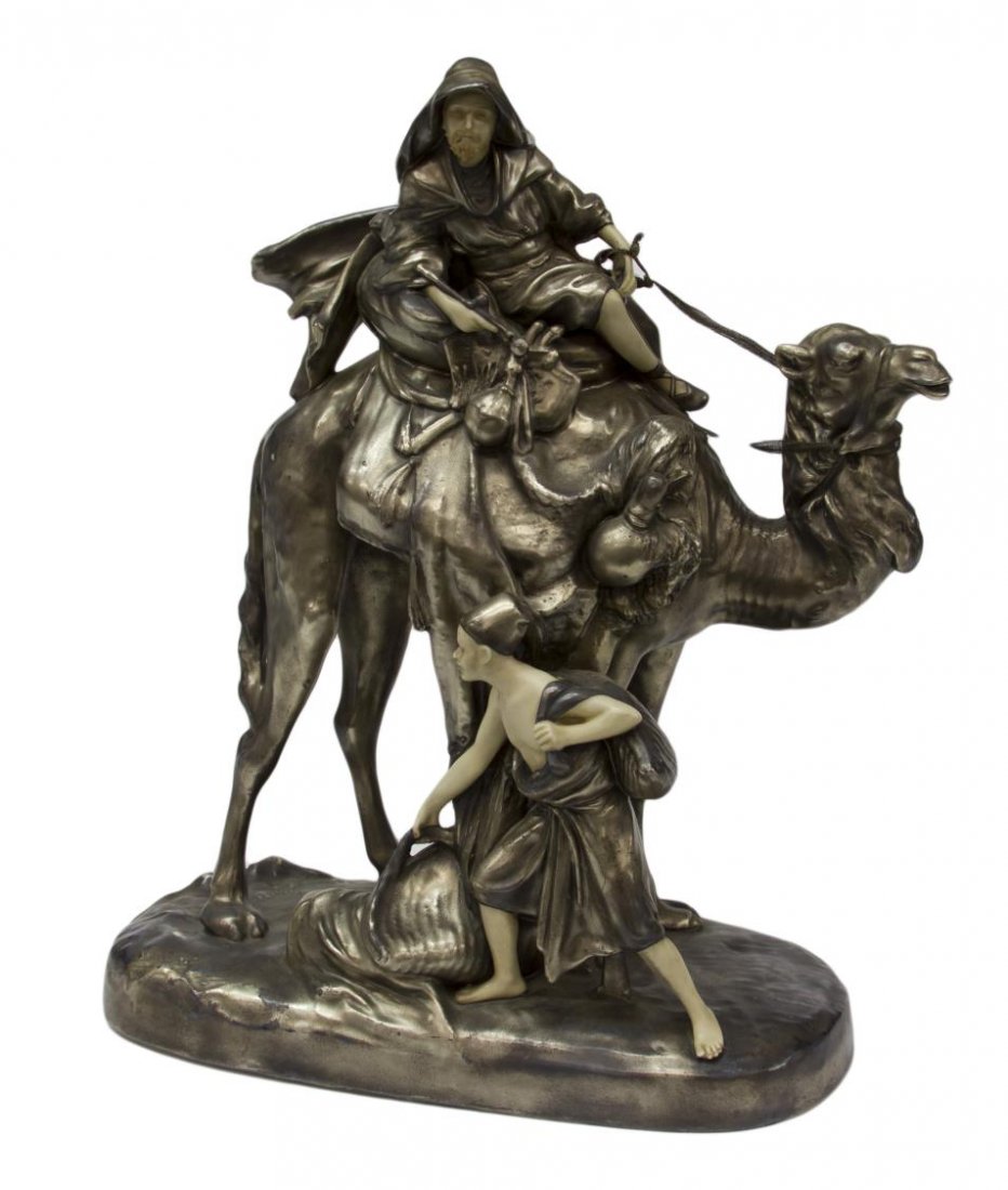 ROYAL DUX PORCELAIN ORIENTALIST FIGURAL GROUP: Large Royal Dux porcelain Orientalist figural group, Arab traveler on camel with attendant carrying bags on foot, early 20th c., in a silver-gilt finish, impressed 1731 4 underfoot, stamped in oval Ma