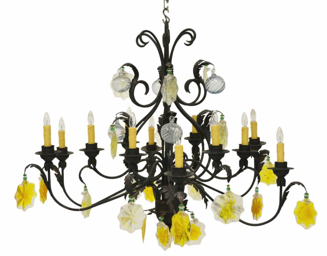 WROUGHT IRON & ART GLASS TWELVE-LIGHT CHANDELIER: Wrought iron two tier twelve-light scrolled arm chandelier, hung with large art glass balls and colored star forms, foliate accents throughout, approx 34.75"h, 42.5"w *Provenance: From the estate of D