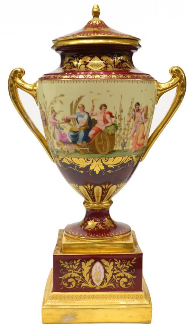 ANTIQUE ROYAL VIENNA PORCELAIN COVERED URN, SIGNED: Royal Vienna porcelain covered urn, "Bacchus and Venus", flanked by gilt handles, the ruby ground finely painted with scrolling gilt foliage, on conforming pedestal base, titled, beehive mark underfoo