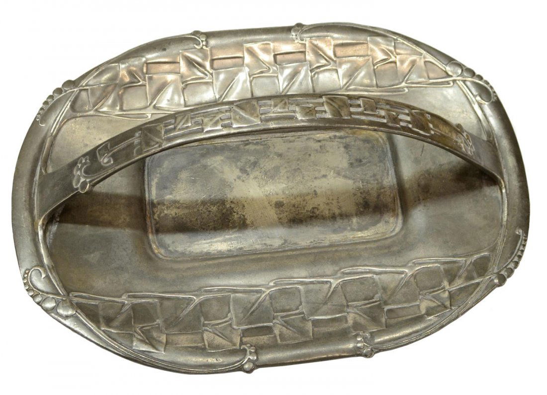 LIBERTY & CO. ARTS & CRAFTS PEWTER HANDLED TRAY: Arts & Crafts pewter handled tray, design by Archibald Knox (1864-1933) for Liberty & Co, marked RD449039, Tudric, 0357, low relief motifs on the low basket with recessed well, approx 4"h, 12"l, 8.75"