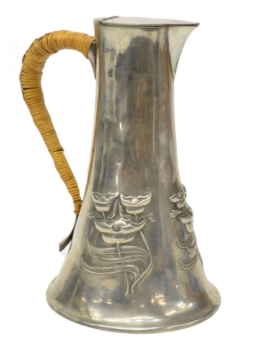 ENGLISH ART NOUVEAU PEWTER HANDLED FLAGON PITCHER: Art Nouveau pewter pitcher, possibly Archibald Knox (1864-1933) for Liberty & Company of London, relief flowers on the body, surmounted by a flat, hinged cover, rattan wrapped handle, stamped 6 028 un