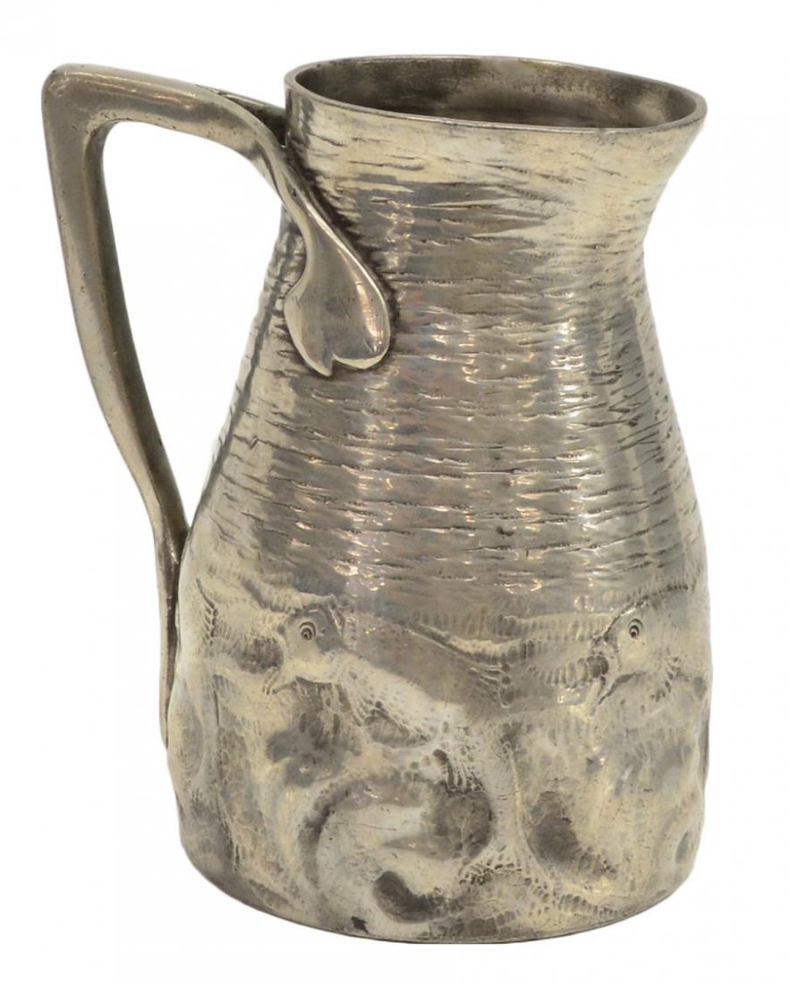 ENGLISH TUDRIC PEWTER FISH & WAVES PITCHER / JUG: English Tudric pewter jug, model 0174, textured upper body above the base detailed with fish among waves, 7"h, 5.75" (to handle), 2lbs *Provenance: Estate of Sam Sitterle (San Antonio, Texas, 1927-201