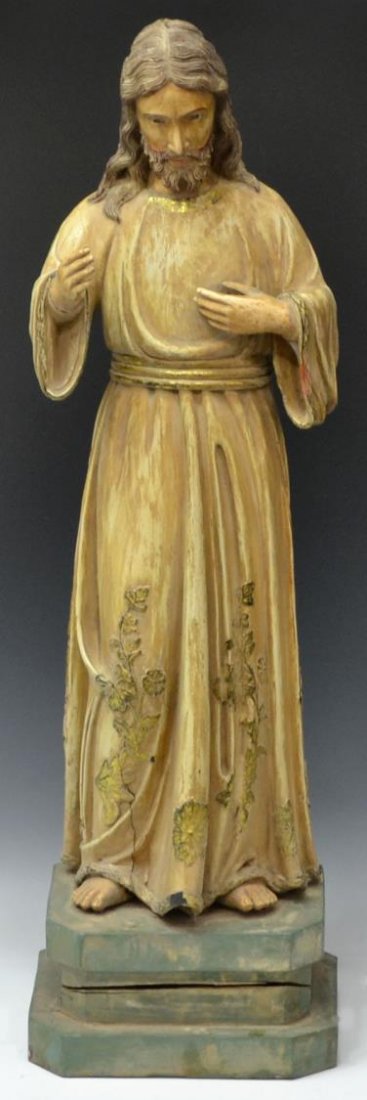 ANTIQUE FRENCH COLONIAL RELIGIOUS STATUE, CHRIST: French Colonial carved wood religious statue, c. 1900, a depiction of Christ with one arm extended outward, gilt accents, glass faced eyes, rising on an integral wood base, wood splits, paint loss, 37
