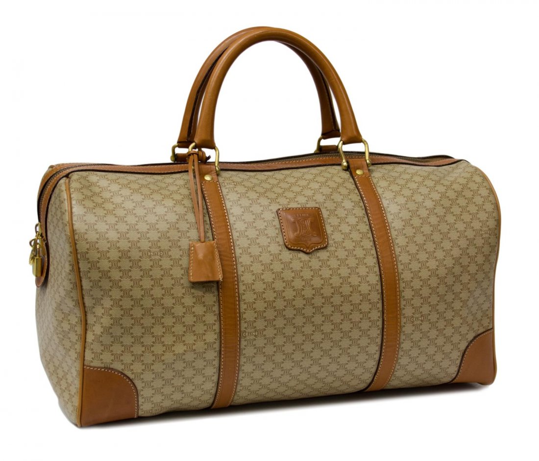 LARGE CELINE MONOGRAM CANVAS TRAVELING DUFFLE BAG: Celine travel bag in beige monogram canvas, brown leather double handles and trim, brown canvas interior with side zipper pocket, accompanied by lock and key, wear to the exterior, 10"h, 17"w, 9"d, 2.