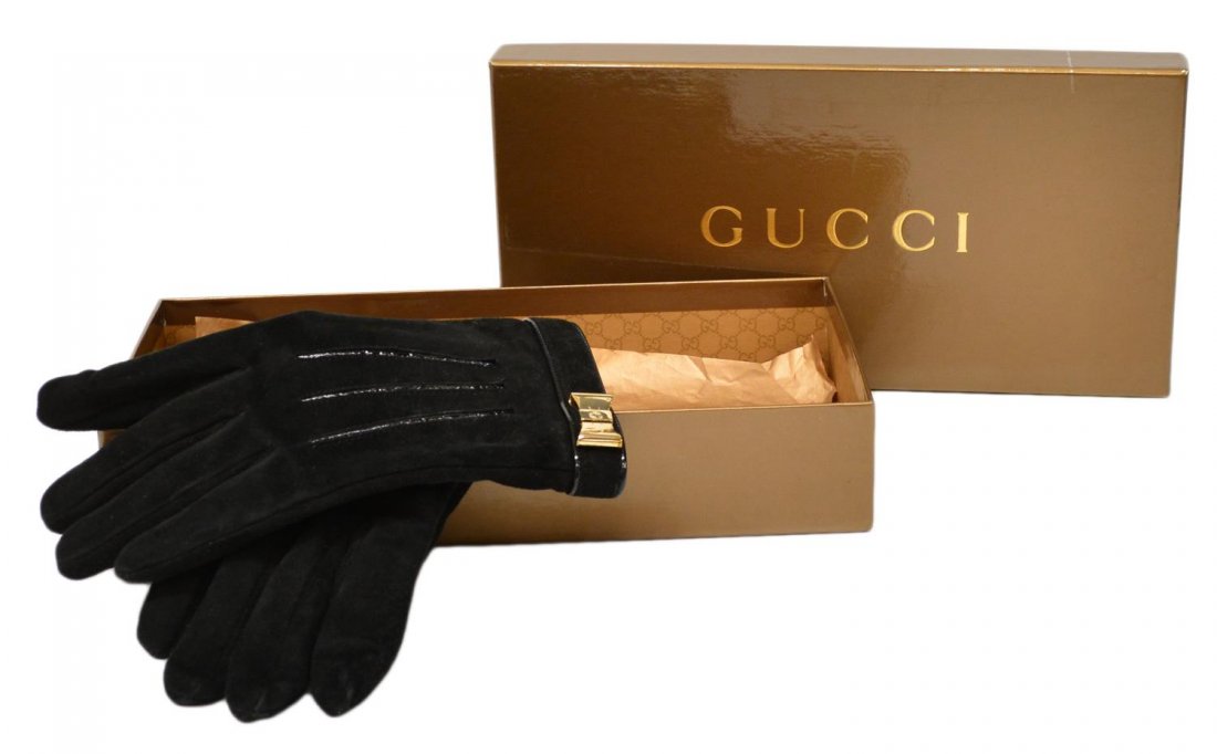 GUCCI BLACK LEATHER GLOVES, CASHMERE INTERIOR: Gucci black leather gloves with cashmere interior, metal bow at cuff, hand stitched tags, original box intact, hardware with some discoloration, box with slight wear and scratches, gloves: 7.5, .5lbs 