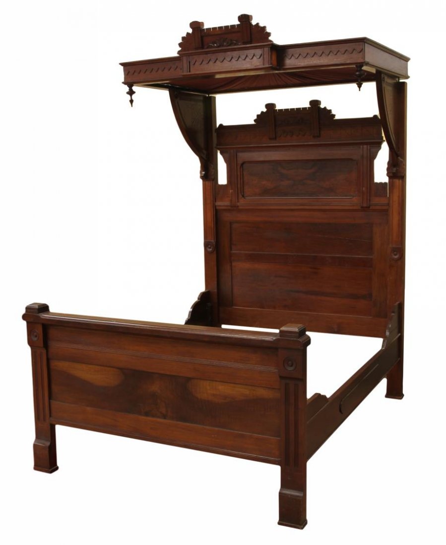 AMERICAN EASTLAKE HALF TESTER BED: American Eastlake half tester bed, c. 1880, foliate carving with a burl panel at the headboard, the canopy in gathered pink fabric, overall: 97"h,81"l, 62"w, interior: 57.5"h, 75"l, 58"w Start Price: