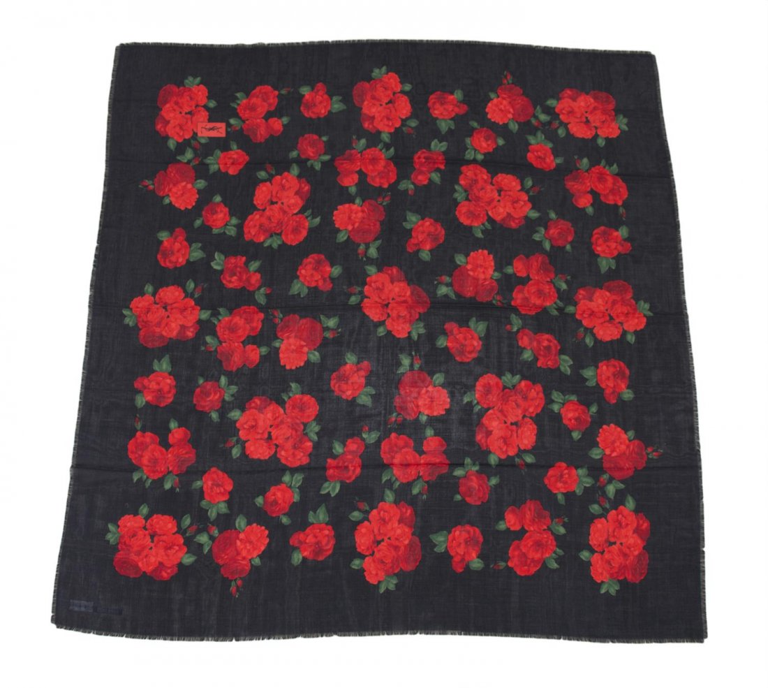 YVES SAINT-LAURENT BLACK WOOL RED ROSE SCARF: Yves Saint-Laurent black wool scarf, hand printed rose motif, fringed edges, retaining tags, original box included, some loss to corners of box, scarf: approx. 52"h, 54"w Start Price: $100.00