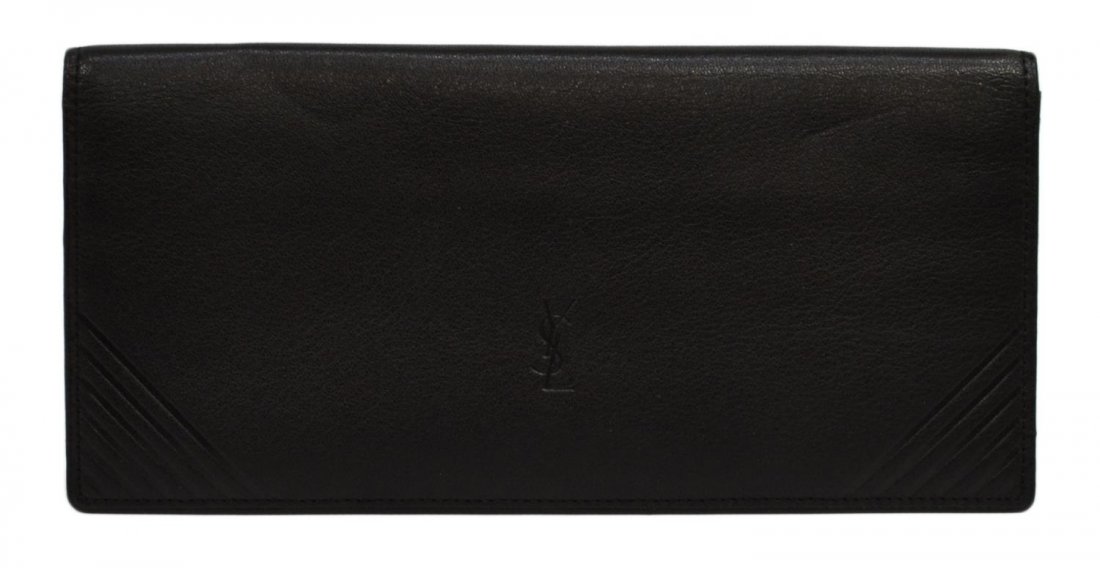 YVES SAINT-LAURENT BLACK LEATHER WALLET: Yves Saint-Laurent black leather wallet, interior with card holders and money pockets, exterior with YSL impression and ribbed corners, wallet: approx. 3.5"h, 7.5"w Start Price: $100.00