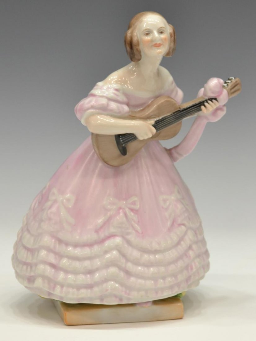HEREND PORCELAIN FIGURE, MRS DERY IN PINK DRESS: Herend porcelain figure, Hungary, lady (Mrs. Dery) in pink dress playing a guitar, marked and incised on base, 8.5"h, 1.5lbs Start Price: $50.00