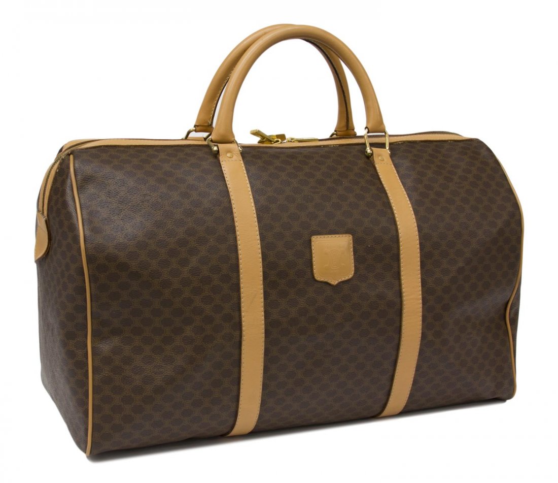 CELINE BROWN MONOGRAM CANVAS TRAVELING DUFFLE: Celine travel bag in brown macadam monogrammed canvas, tan leather double handles and trim, zipper closure designed to meet at the center, tan interior with single side zipper, accompanied by lock and