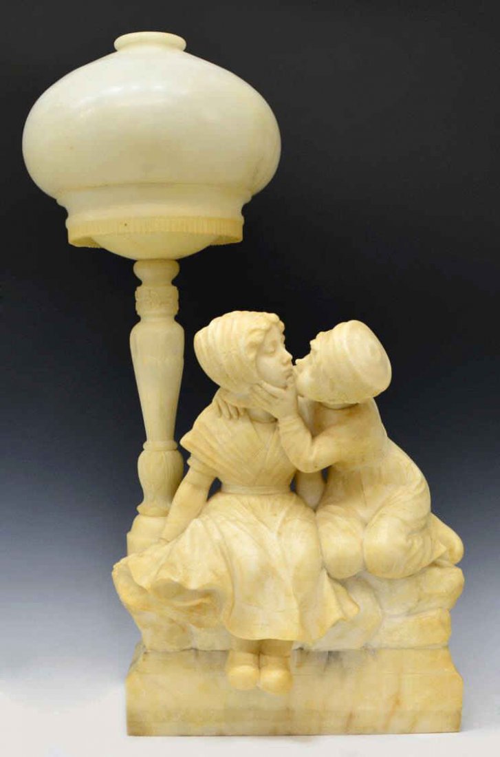 LARGE G. MASCAGNI ALABASTER FIGURAL TABLE LAMP: Italian alabaster figural table lamp, a young Dutch boy leans in for a kiss, signed G. Mascagni (Mascogni ?), the boy and girl seated under a street lamp, incised and carved detail, intact with fractu