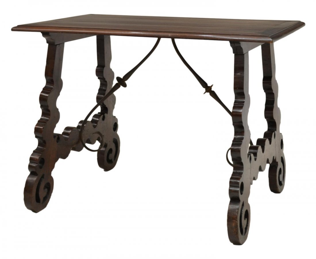 FINE SPANISH BAROQUE TABLE ON WELL CARVED SUPPORTS: Spanish Baroque style library table, fashioned from antique and later elements, the rectangular top raised on well carved antique legs, joined by iron stretchers, approx 31.75"h, 43.25"w, 28"d Start P