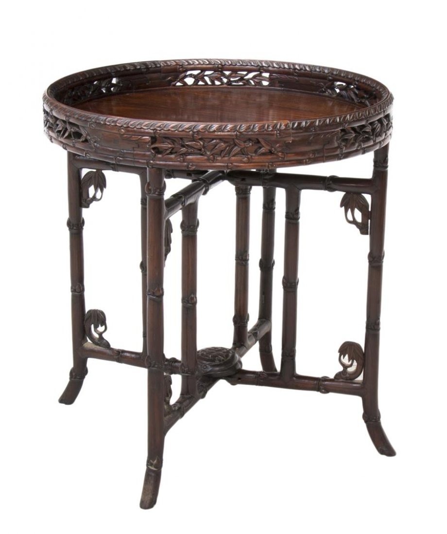 CHINESE ROSEWOOD BAMBOO TRAY TABLE, QING/ REPUBLIC: Chinese rosewood tray table, late Qing / Republic period, the circular tray having carved border above pierced bamboo gallery, resting on the folding stand carved as bamboo stalks, centered by a medal