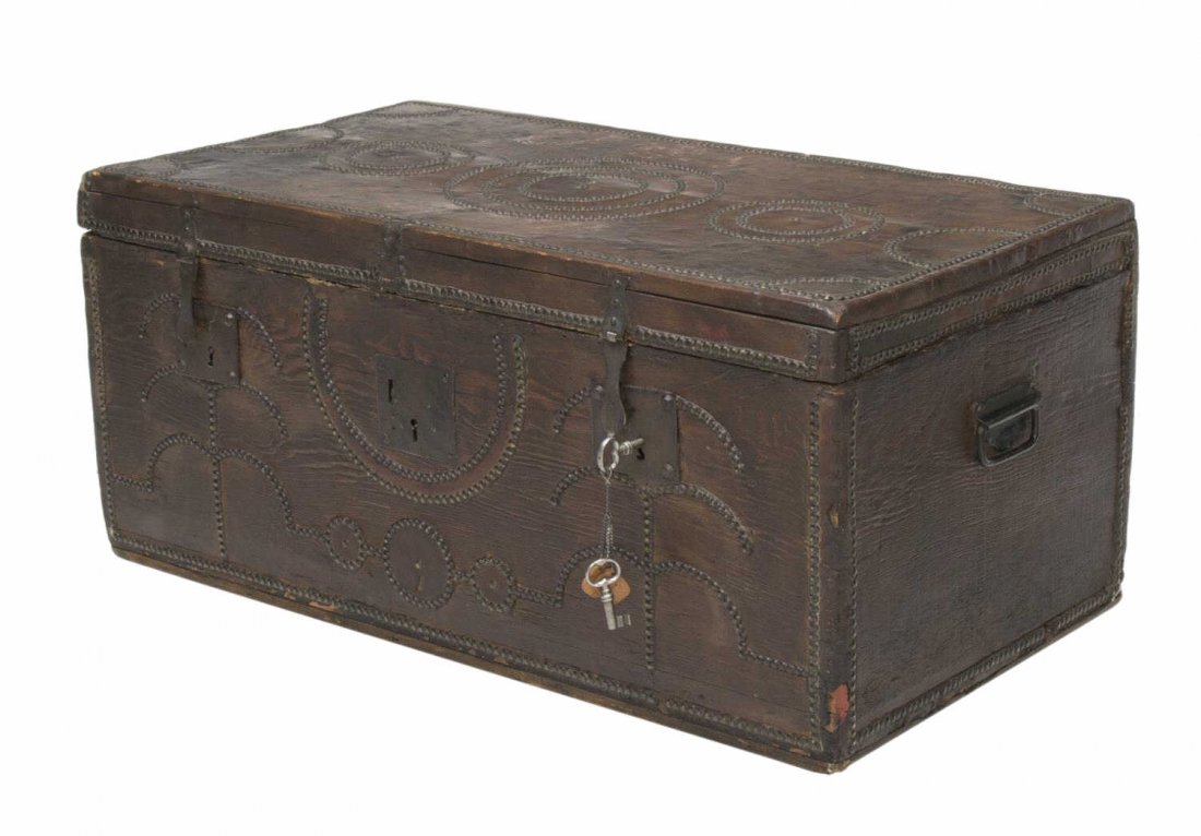 EARLY 19TH C. SPANISH LEATHER & WOOD TRUNK: Antique Northern Spain coffer, early 19th c., a leather covered wood trunk with nail head decoration, large strap hinged locks opening to a later paper lined interior, complete with original keys, lac