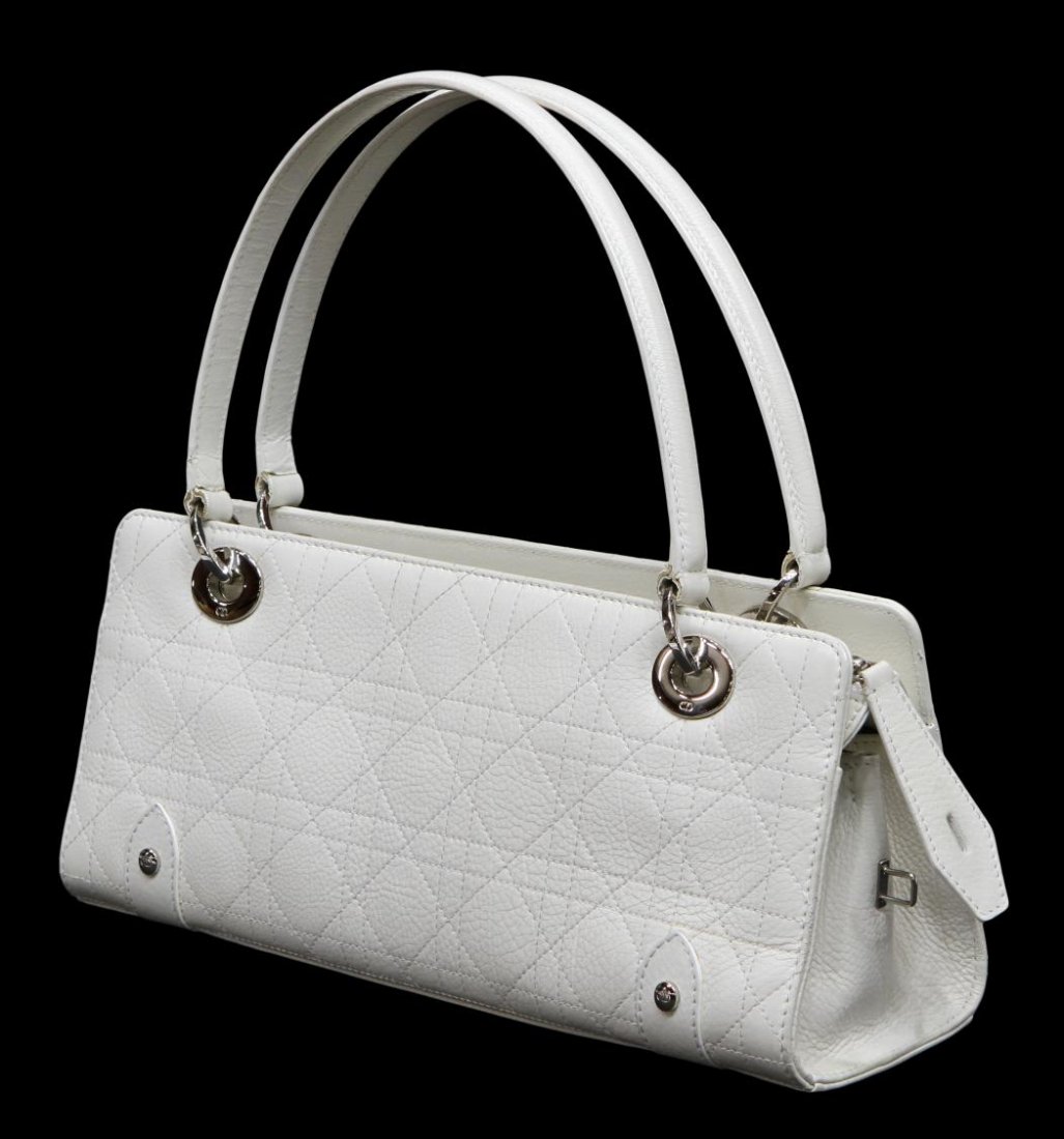 CHRISTIAN DIOR WHITE CANNAGE LEATHER HANDBAG: Christian Dior handbag in white cannage leather with silver tone logo and hardware, black logo interior with two sections and single zip pocket, lock and keys, set on silver tone feet, some wear to le