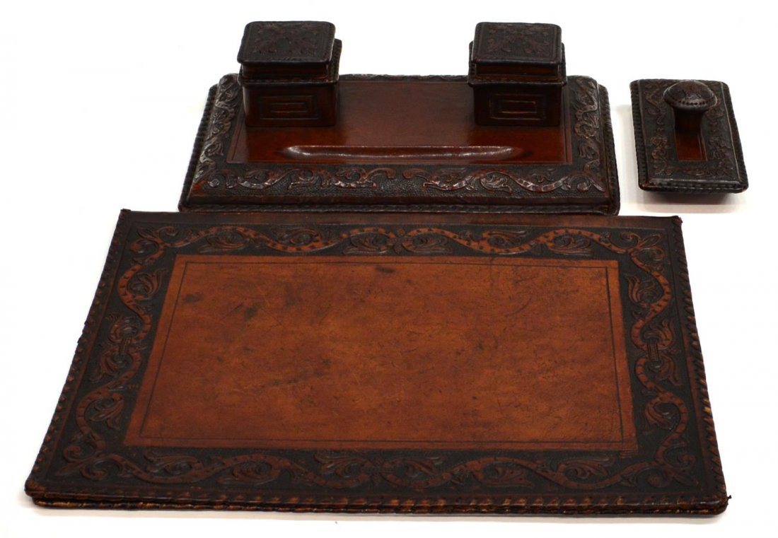(3) SPAIN EMBOSSED LEATHER DESK SET: (set of 3) Embossed leather desk set, Spain, detailed border with scrolling tendrils on a pebbled ground, comprising (1) large folio, (1) pen and ink tray, rip in corner of ink holder, and (1) ink blo