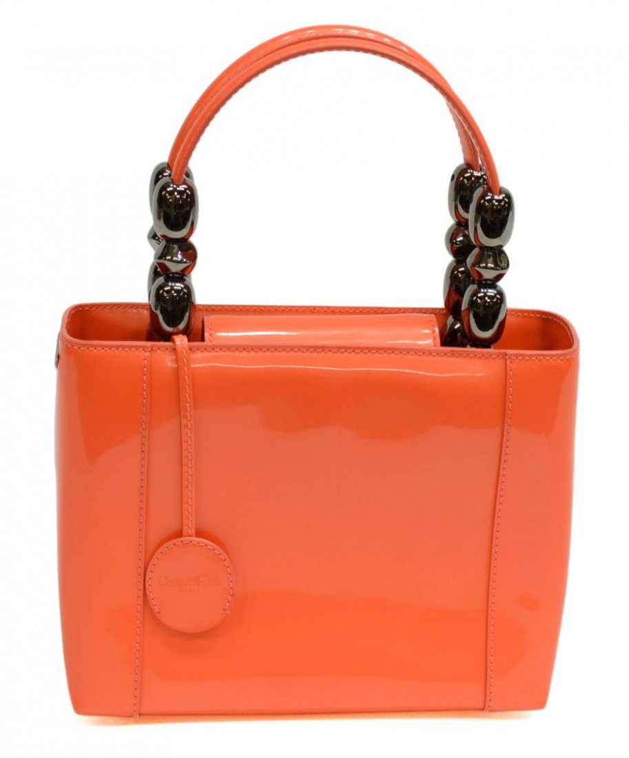 CHRISTIAN DIOR MARIS PEARL PATENT LEATHER HANDBAG: Christian Dior 'Maris Pearl' patent handbag in coral orange, single zipped pocket to the interior, lined in tan logo fabric, accompanied by worn dust bag, bag: 7"h, 8.5"w, 1.25lbs Start Price: $50.00