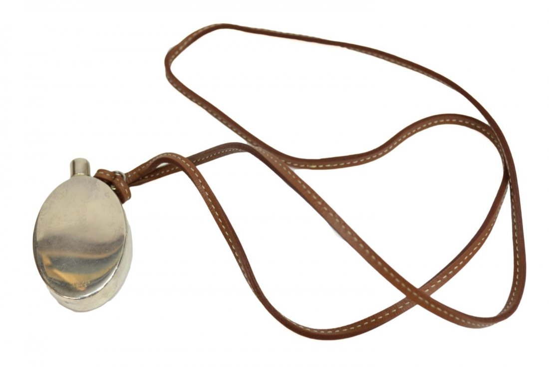 HERMES SILVER TONE PERFUME AMULET ON NECK CHAIN: Hermes perfume holder in silver tone with screw on top, leather necklace attached, mark on top, surface wear to bottle, bottle: approx. 2.5"h Start Price: $100.00