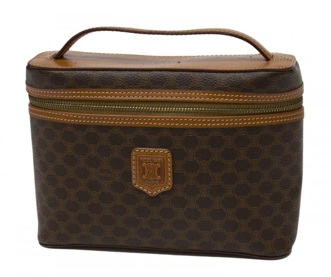 CELINE MONOGRAM CANVAS & LEATHER COSMETIC CASE: Celine cosmetic bag in brown macadam monogrammed canvas, single leather handle, light brown interior, minor wear to the exterior, bag: approx 6"h, 8.5"w, 3"d, .75lbs Start Price: $40.00
