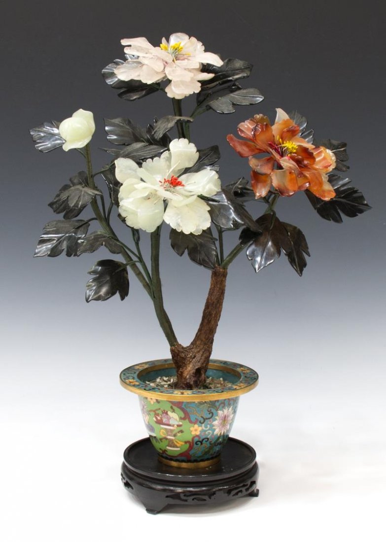 CHINESE HARDSTONE FLOWERING TREE, CLOISONNE POT: Chinese hardstone tree, flowering branches of rose quartz, jade, and carnelian, set in a cloisonne pot having lotus scrolls and cartouches enclosing scholar items, accompanied by wooden stand, small l