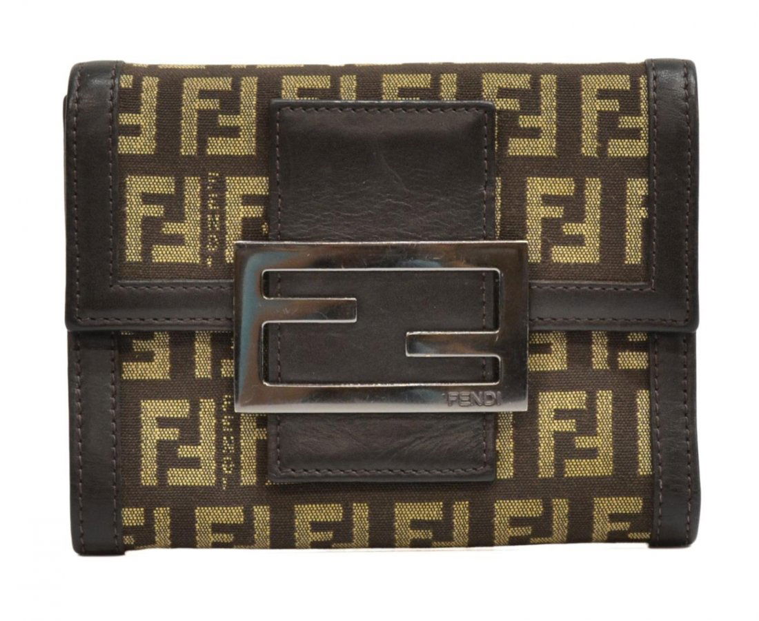 FENDI BROWN MONOGRAM CANVAS WALLET: Fendi wallet in brown monogrammed canvas with silver tone buckle, brown leather interior and trim, including zipper pocket and card slots, some wear with age, wallet: approx 4"h, 5"w, 1"d, .25lbs Star