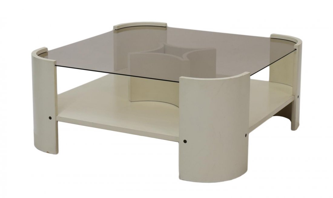 ITALIAN MODERN PAINTED & GLASS TOP COFFEE TABLE: Italian modern coffee table, c. 1960's / 70's, cream color table having curved edges and central stylized d?cor, smokey glass top, approx 14"h, 33.25"sq Start Price: $150.00