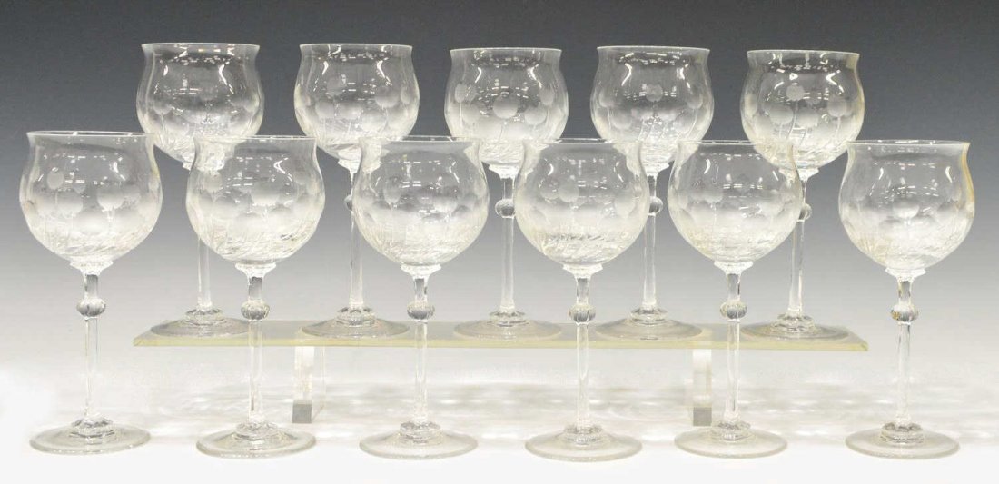 (11) C. JOSEF RIEDEL CUT CRYSTAL GOBLETS, STEMWARE: (set of 11) Claus Josef Riedel finely cut crystal wine goblets, Austria, (1925-2004), in a stylized floral motif with a flared rim, lobed stems, circular base, company logo acid mark underfoot as pict
