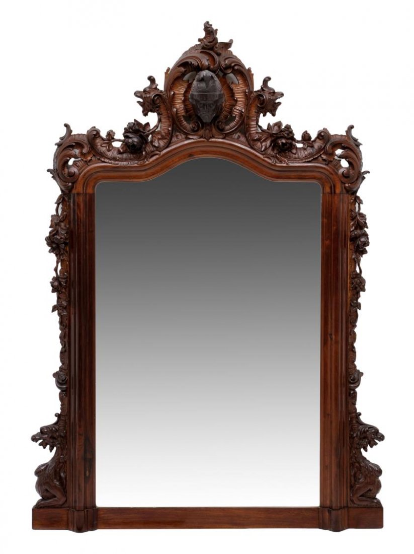 MONUMNENTAL RENAISSANCE STYLE FIGURAL MIRROR: Monumental Italian Renaissance style carved walnut wall mirror, a pair of demi griffins flank the crest centered by the high relief carved head of a knight, floral scrolls and rocaille work frame a fl