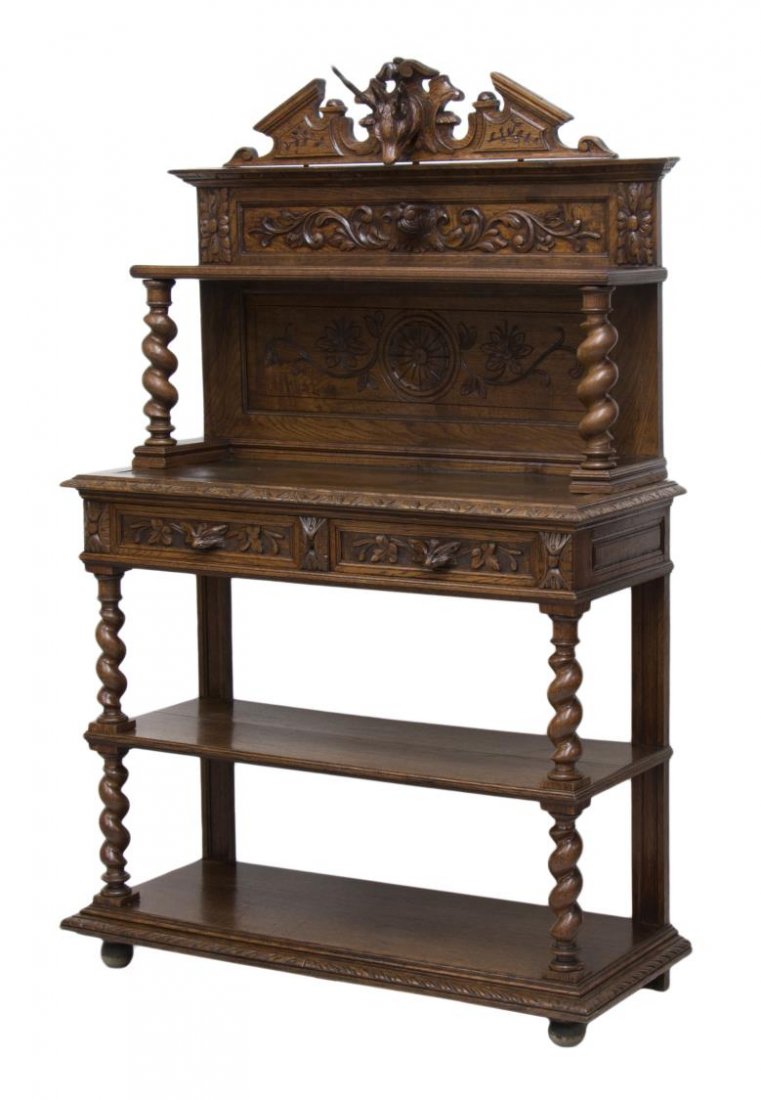 BLACK FOREST STAG CARVED TIERED SERVER: French Henry II carved oak server, 19th c., a stag head in relief cresting the tiered server with spiral supports, floral incised panel back joining the top with carved border, two aligned drawer havi