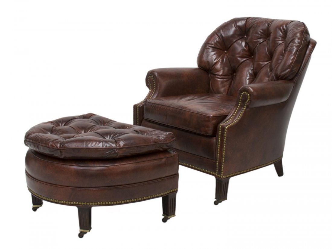 HANCOCK & MOORE BUTTONED LEATHER CHAIR & OTTOMAN: Brown buttoned leather arm chair and ottoman by Hancock and Moore, N.C., both on square reeded legs with castors, chair: 34"h, 32"w, 25"d, ottoman: 16"h, 26.5"w, 21"d Start Price: $300.00