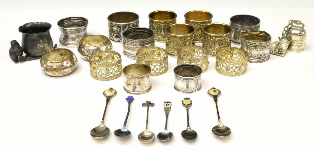 (25) COLLECTION SILVERPLATE NAPKINRINGS & SPOONS: (lot of 25) Collection of mostly silver plate table items, comprising: (17) napkin rings, varying intricate designs, one having polychrome enamel exterior, another in silver with Minerva head hallmark
