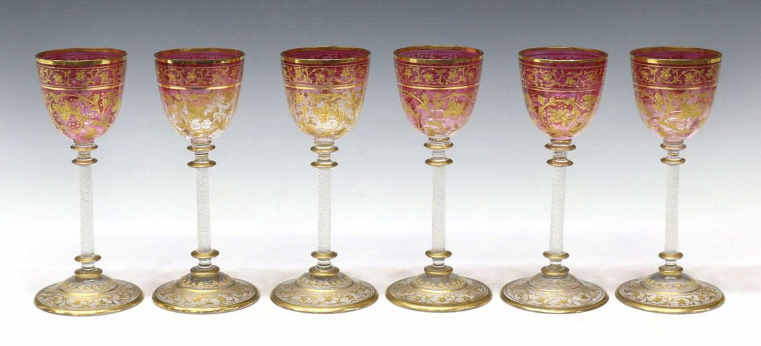 (6) BOHEMIAN MOSER STYLE GILDED CRANBERRY STEMWARE: (lot of 6) Bohemian parcel gilt stemware, in the style of Moser with delicately gilded floral and foliate design, raised enamel accents, cranberry bowl on a textured spiral stem, gilt banding to rim a