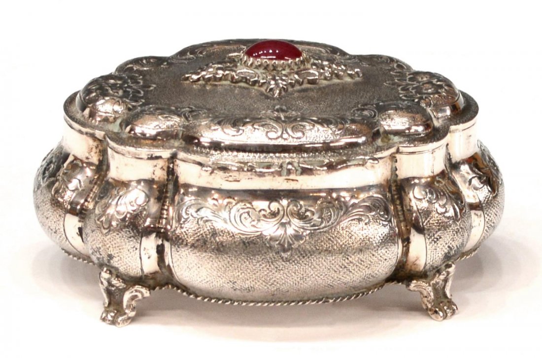 ORNATE ITALIAN 800 SILVER CABOCHON INLAID BOX: Italian 800 silver dresser box, lobed form having chased and repousse floral and foliate vines on a textured ground, carnelian tone cabochon inset on the hinged lid, 2"h, 4.75"l, 3.5"w, 8.35ozt Start 