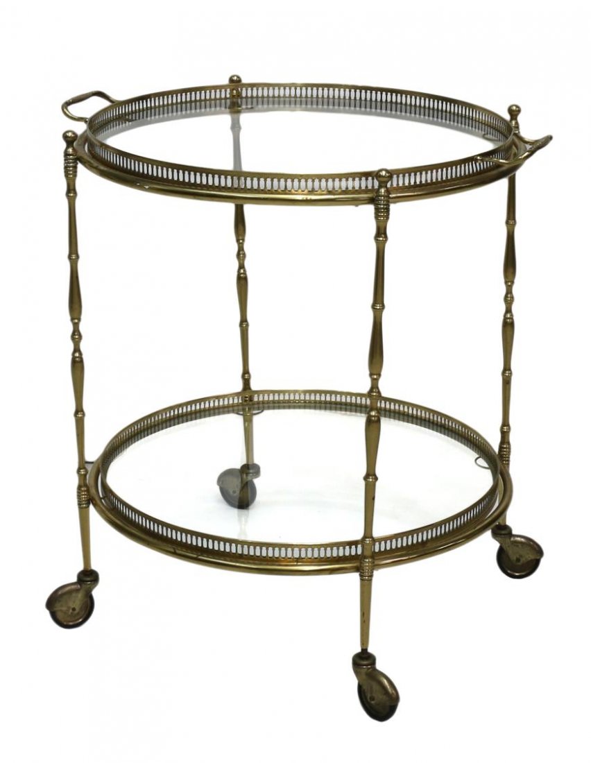 ITALIAN BRASS & GLASS SERVICE CART: Italian circular brass framed service cart, the top with a removable handled glass top tray over a lower conforming tier, raised on shaped supports with castors, 26"h, 21.75"d less tray handles Start