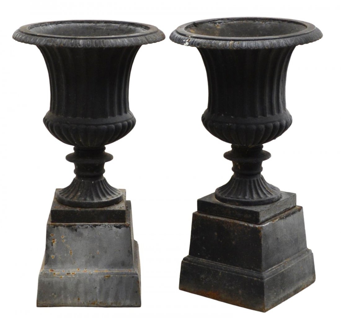 (PAIR) CAST IRON PLANTERS: (lot of 2) Cast iron planters, 20th c., vasi form rising on a separate tapered square base, overall: 26.5"h, 14.75"diameter Start Price: $80.00