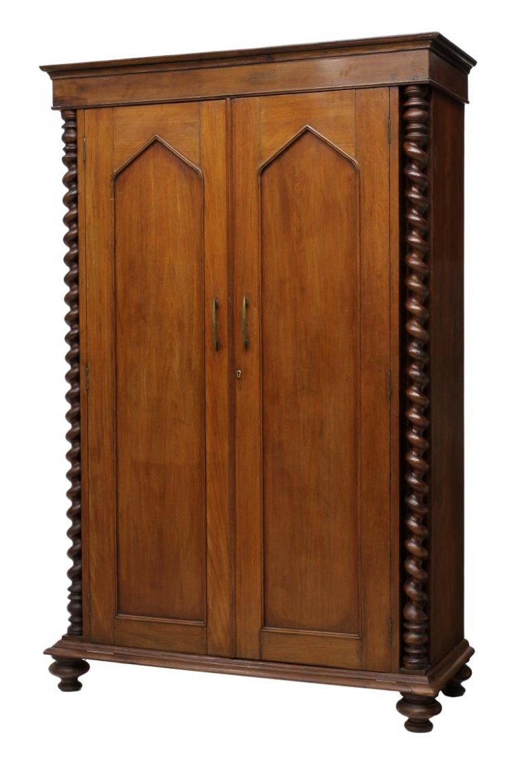 TEAKWOOD LINEN PRESS, TWIST COLUMNS: Teakwood linen press with protruding cornice over two doors opening to interior shelves, flanking full length twist columns, rising on a stepped base with bun feet, 76.5"h, 50"w, 19.5"d Start Price: $