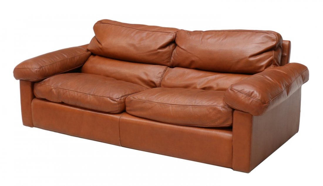 ITALIAN MODERN LEATHER SOFA, POLTRANA FRAU: Italian brown leather modern sofa, c. 1980, by Poltrana Frau, a low back with oversize arms, two back and seat cushions, raised on short bun feet, 26.25"h, 76"l, 40"d Start Price: $400.00