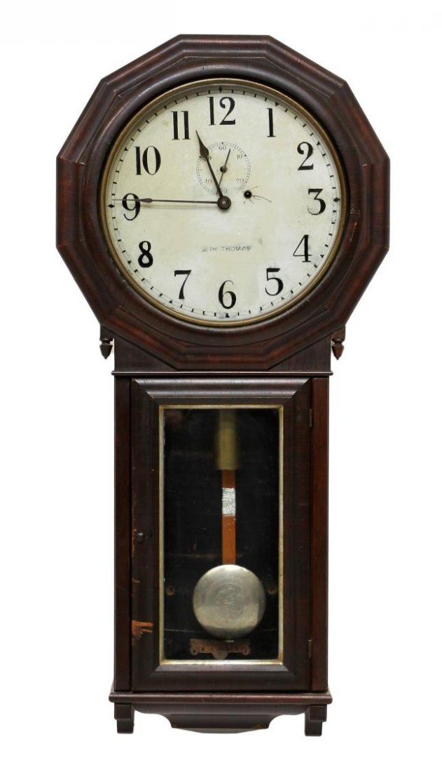 SETH THOMAS WOOD HANGING WALL REGULATOR CLOCK: Seth Thomas wood wall regulator clock, likely model #3, weight driven with pendulum, veneer case with two finials at the bottom of the face, lacking interior sticker and bottom finials, veneer loss, a