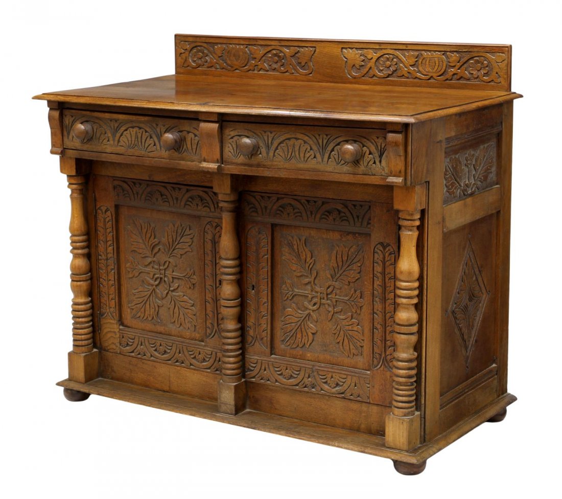 NICELY CARVED VICTORIAN OAK SIDEBOARD: Victorian oak carved sideboard, c. 1890, having relief and incised foliate carved drawers, doors, side panels, the rectangular top with a short carved back splash, two frieze drawers above two doors w