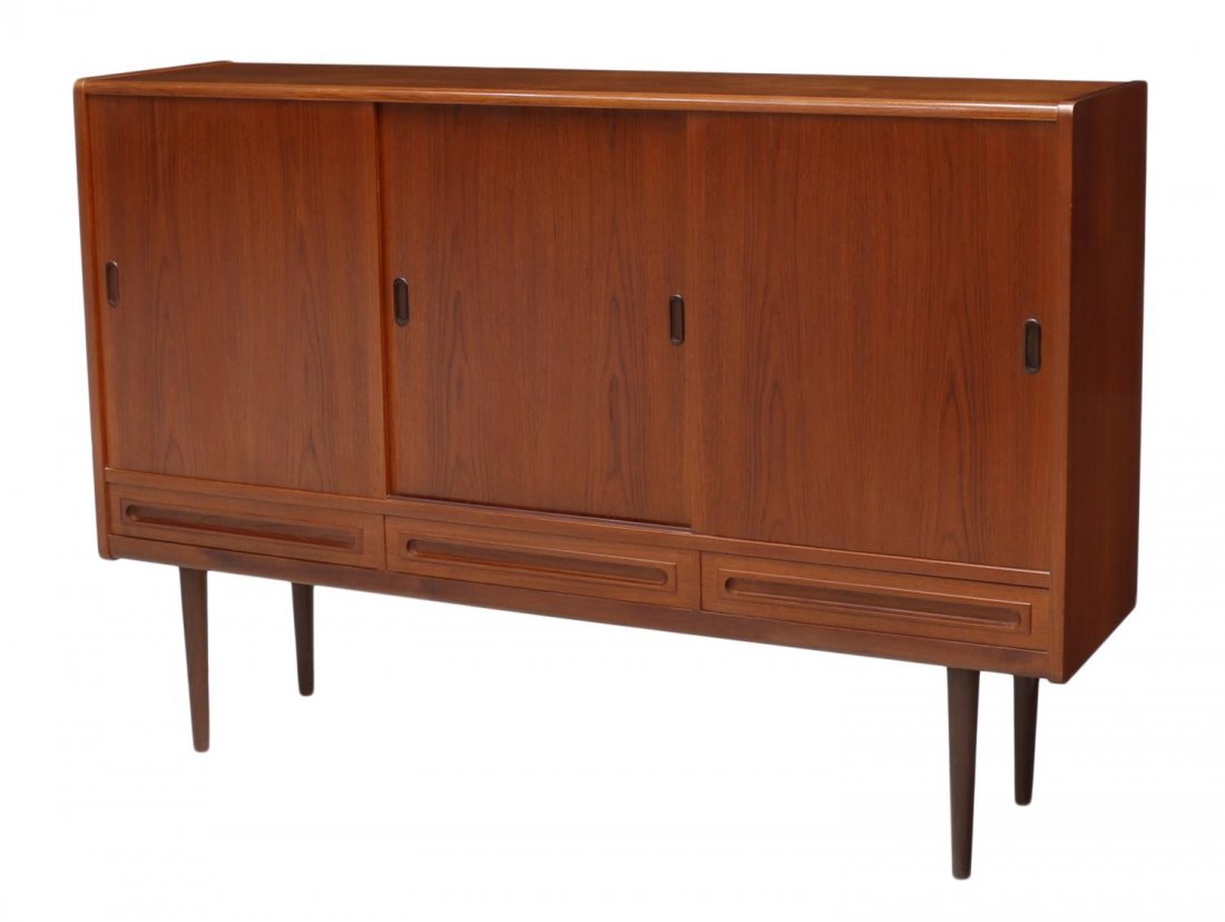 DANISH MID-CENTURY MODERN TEAKWOOD SIDEBOARD: Danish mid-century modern teakwood sideboard, 1950's, three sliding doors over three drawers, the interior with shelve and drawers, all rising on tapered turned legs, 46"h, 87"w, 17"d Start Price: $40
